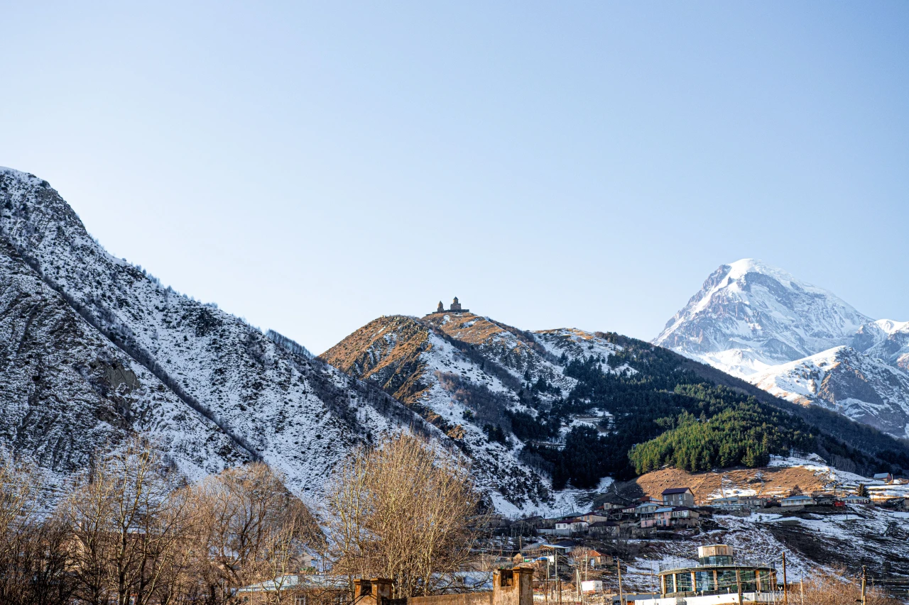 Snow-capped Mount Kazbek and the Gergeti Trinity Church in Kazbegi, Georgia