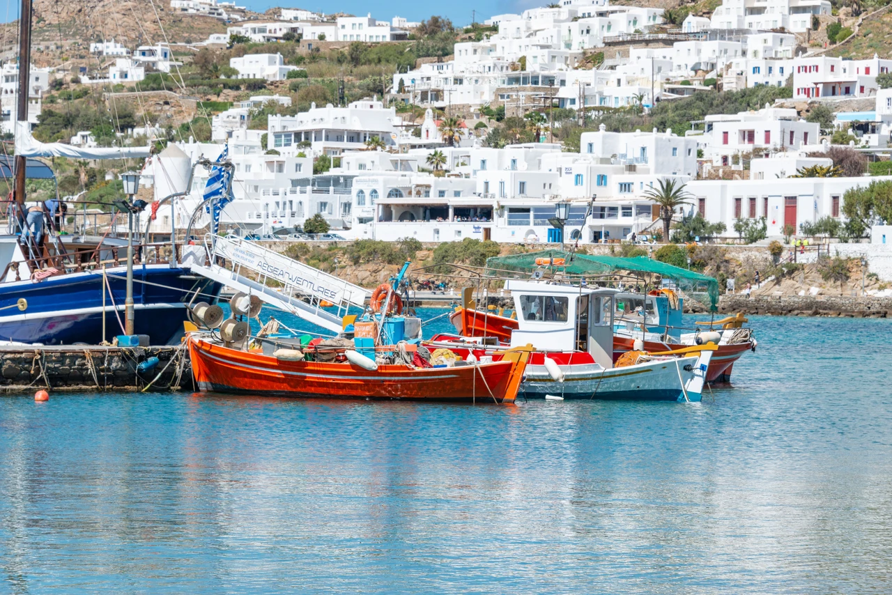 Small boats moored in a quiet Greek island port, similar to Kalymnos's harbor towns of Pothia and Myrties