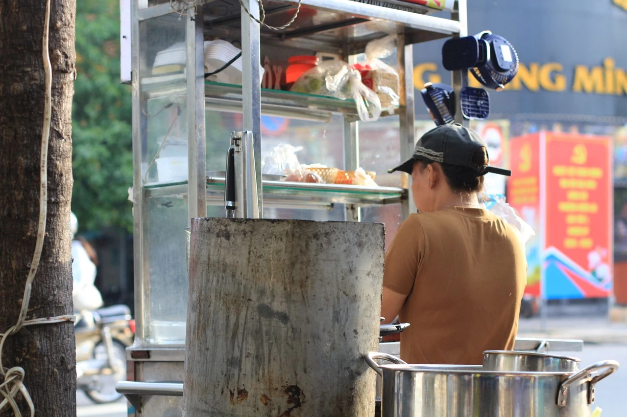 Street food vendor cooking at a stall in Ho Chi Minh City, Vietnam